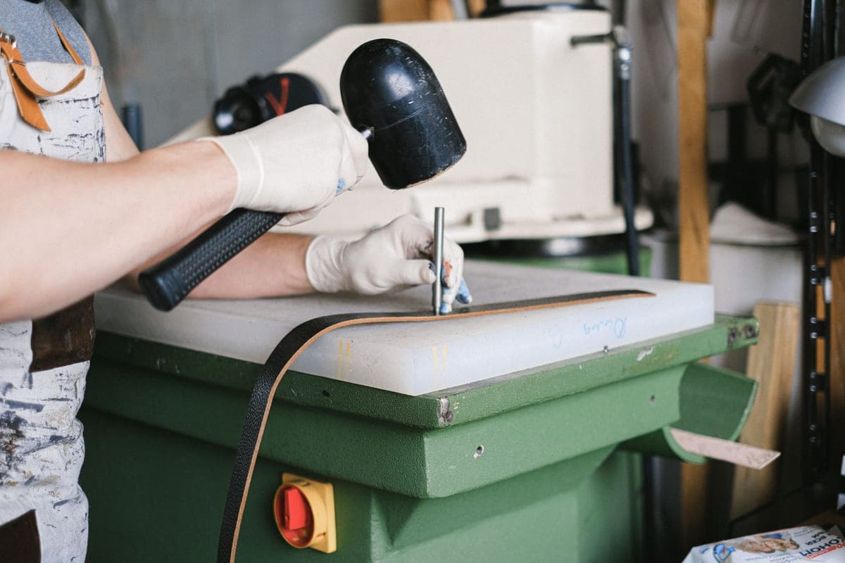 A workbench with hand tools and a pair of leather work boots
