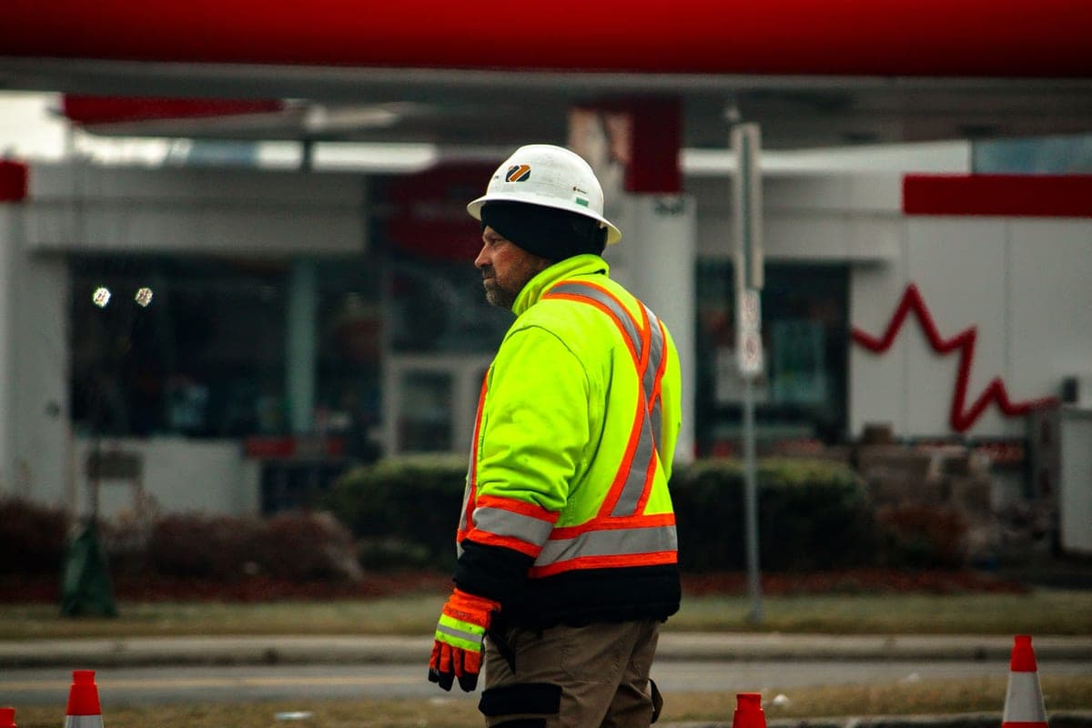 A construction worker in a winter jacket on a cold-weather job site