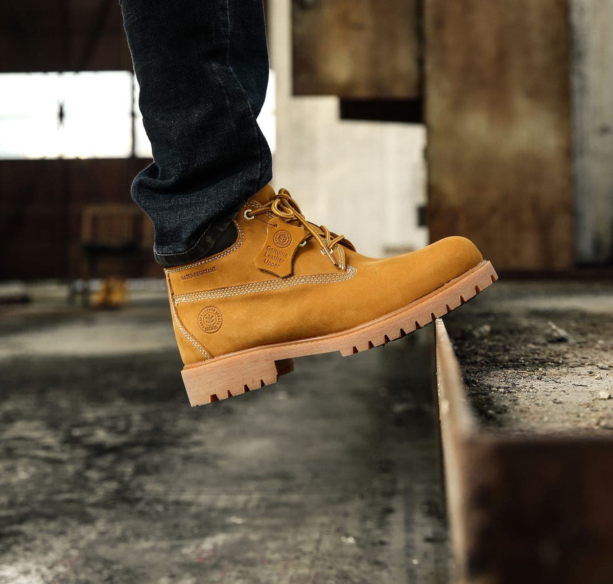 A pair of leather steel-toe work boots on a workshop floor